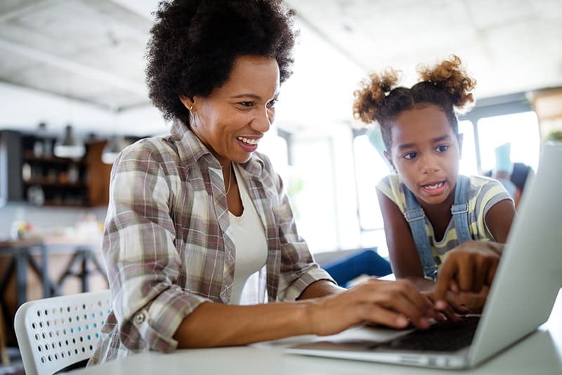 mother and daughter using home wifi