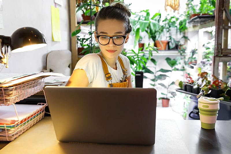 young woman working from home on laptop